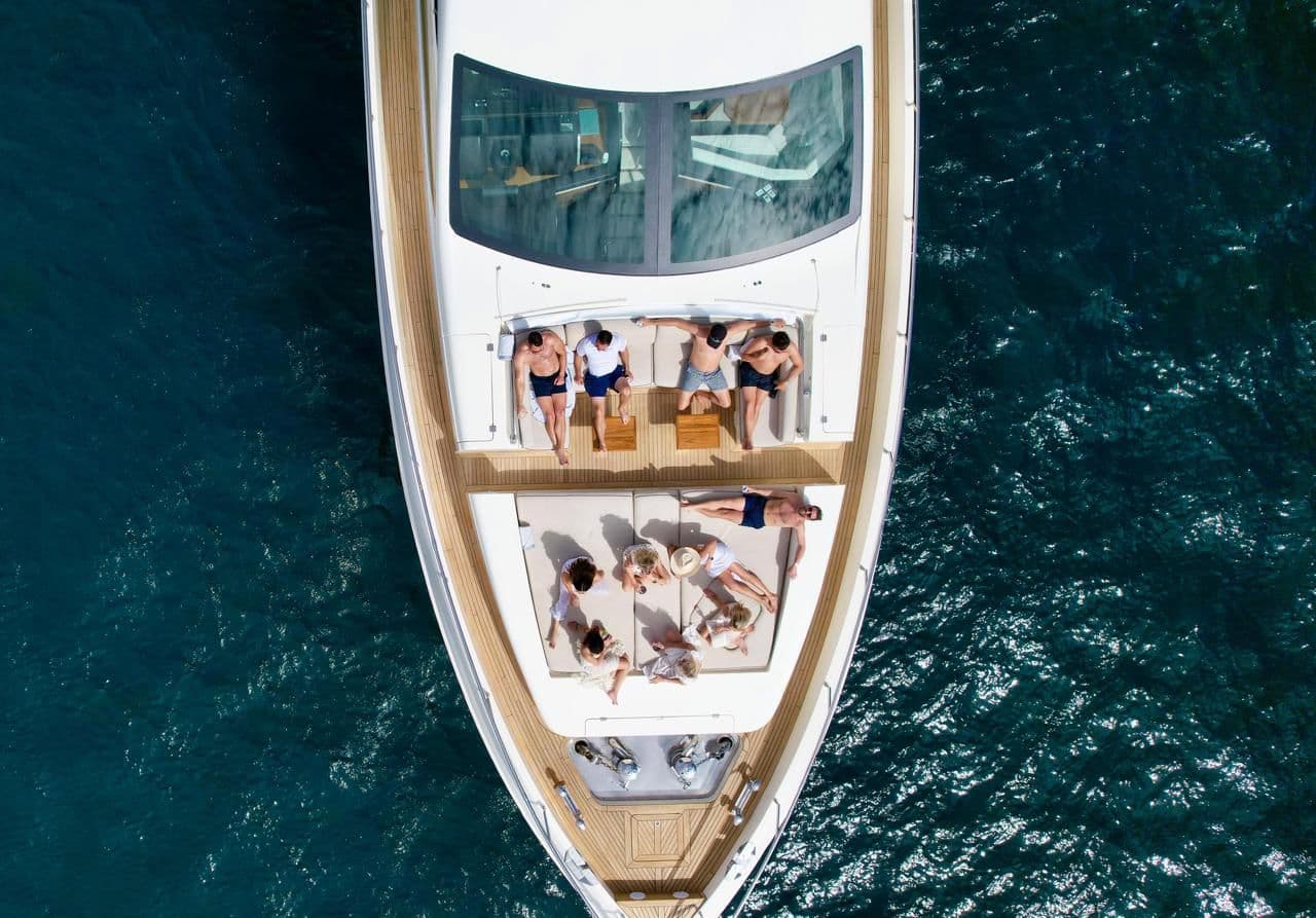 Andreika yacht bow sunpad in Cabo San Lucas with guests lounging on teak