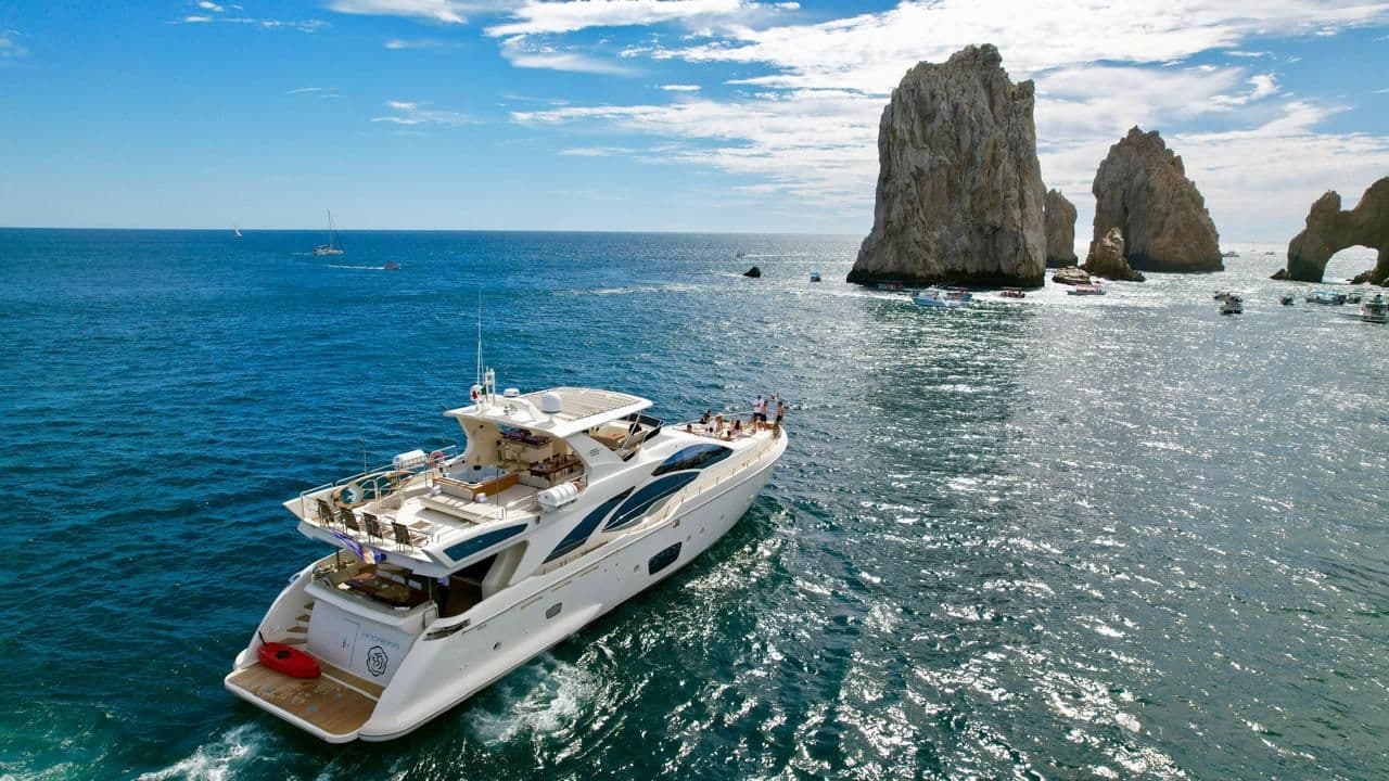 Andreika yacht — ANDREIKA 95ft Azimut charter cruising past El Arco in Cabo San Lucas, name on the transom