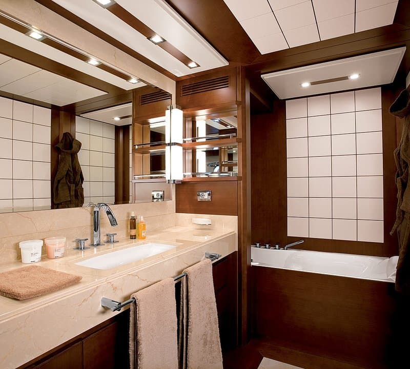 Andreika yacht ensuite bathroom on the 95ft Azimut with marble vanity and tub